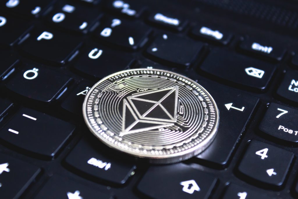 large coin placed top black computer keyboard Filsx